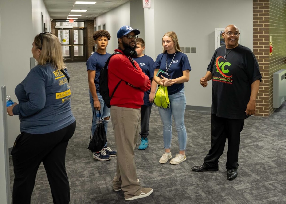 DaVante' Goins in conversation with students and a youth program leader